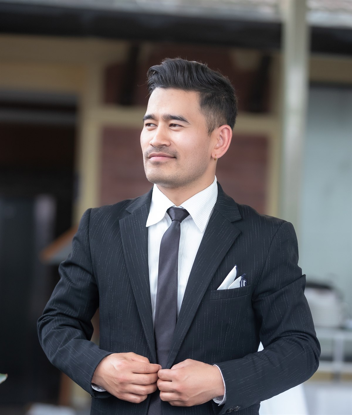 Zatil Shrestha, full stack developer, in a dark pinstripe suit